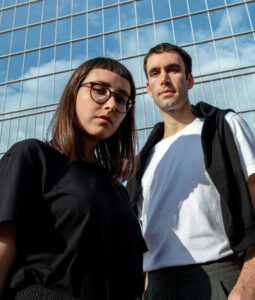 Couple in front of a glass building