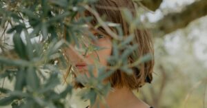 Woman among olive branches