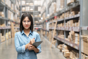 Young asian worker, owner, entrepreneur woman holding smart tablet looking at camera with concept e fulfillment service business warehouse management stock online.